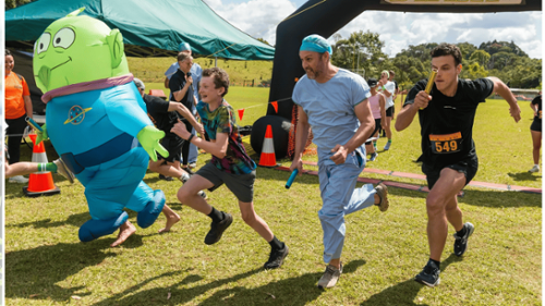 Daley Street Dental team in scrubs running relay at Alstonville Wollongbar Fun Run with alien mascot